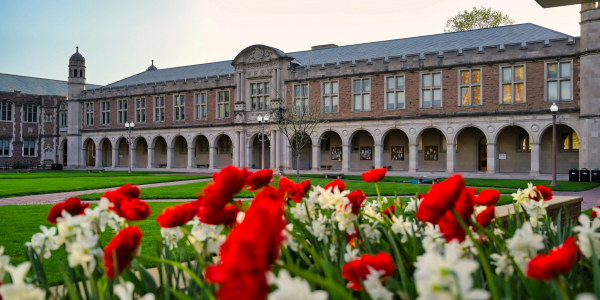 Ridgley Hall, midday in spring, with red and white flowers in the foreground